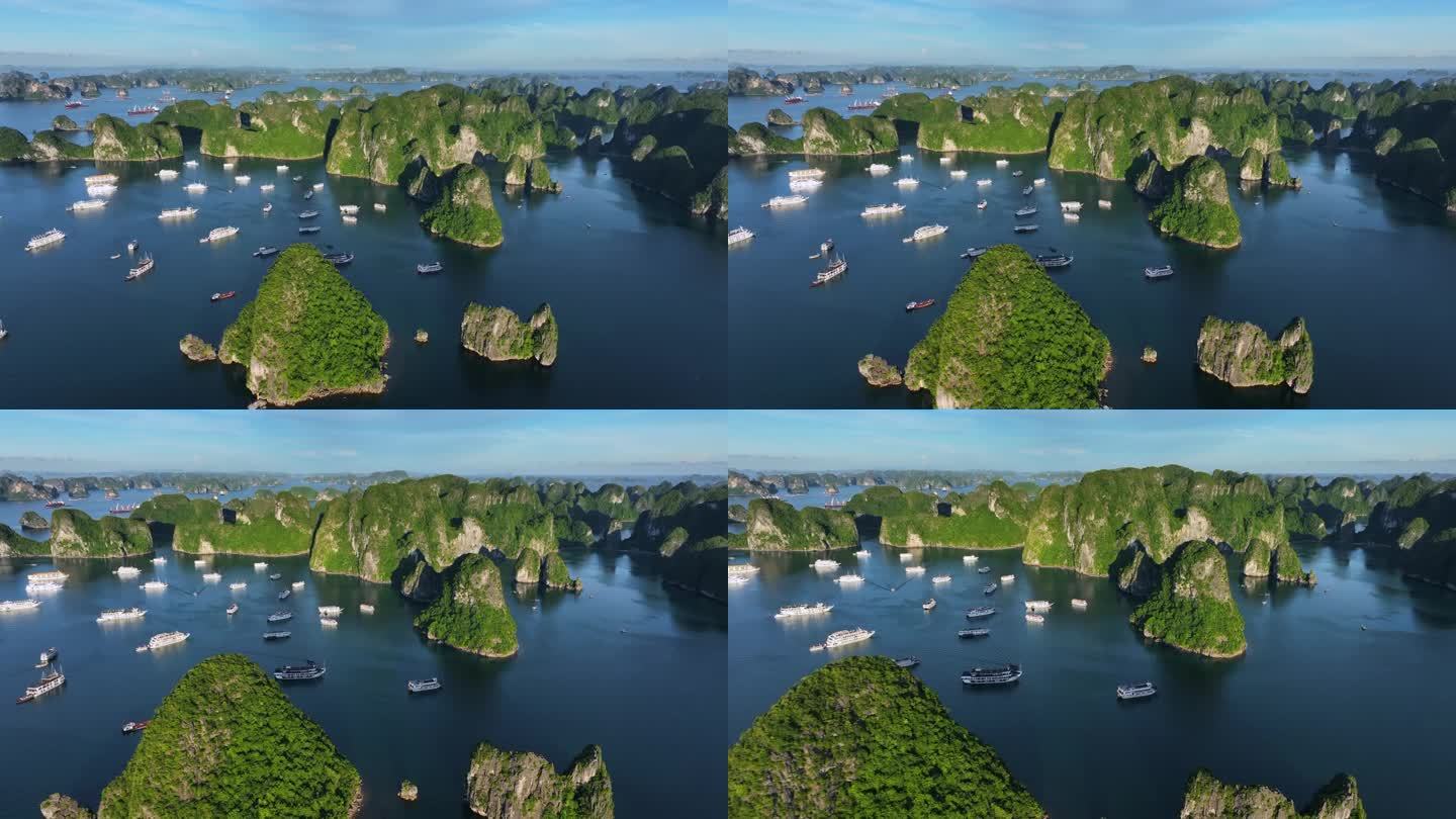 在越南北部下龙湾的海上，航拍无人机拍摄的观光船与岩石山的淡蓝色天空