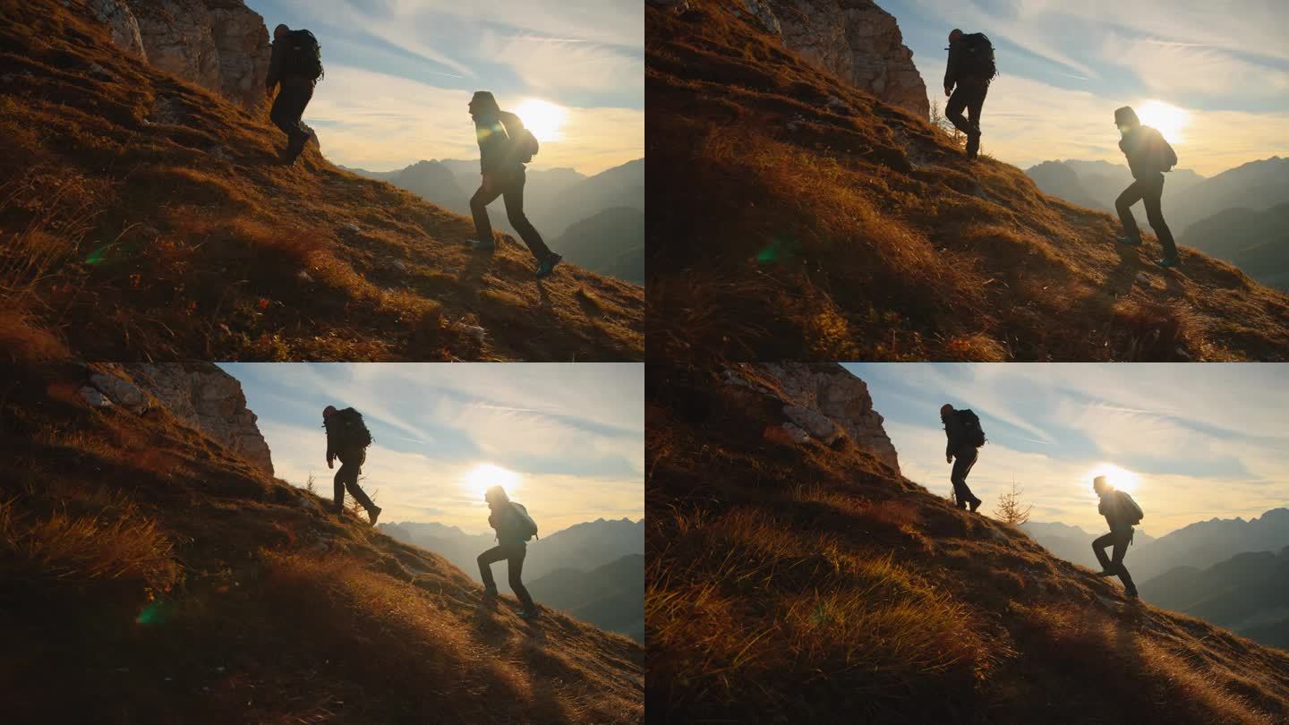 一起攀登:一对夫妇在日落时分征服高山