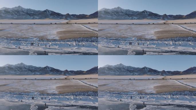 航拍冬季新疆赛里木湖雪山环湖公路夕阳车辆