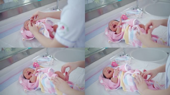 护士牵着新生婴儿的手