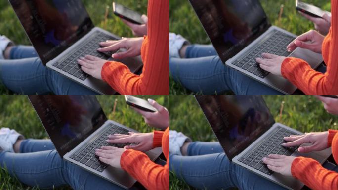 女人在户外使用电脑的手