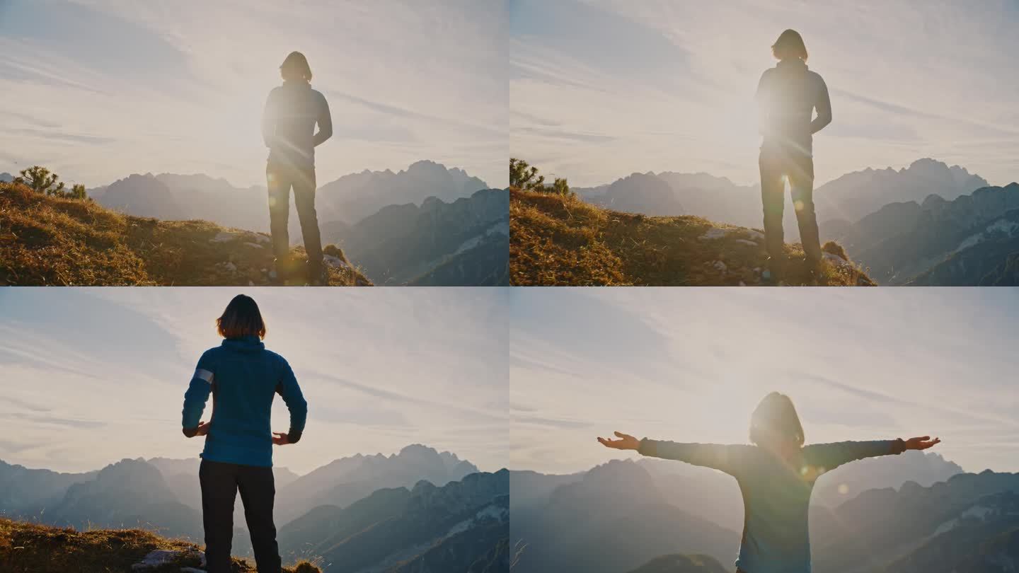 拥抱大自然的辉煌:女人陶醉在山的威严中，她站在山顶，双臂张开
