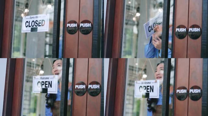 亚洲老板微笑在玻璃门后面，打开标志-欢迎顾客光临