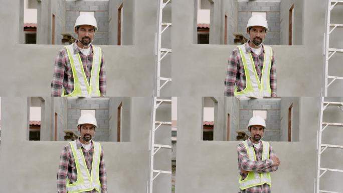 专业男建筑工人站在未完工的水泥建筑和梯子前。自信微笑的亚洲工程师，戴着白色头盔和黄色背心。骄傲的家伙
