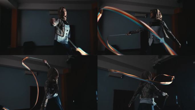 一个人在黑暗的室内练习射箭的剪影，聚焦于弓和箭的全开。