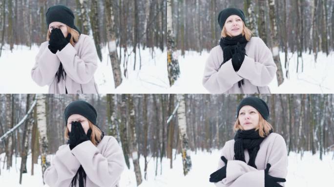 冬天的女孩在公园雪林里散步时用手搓风取暖。