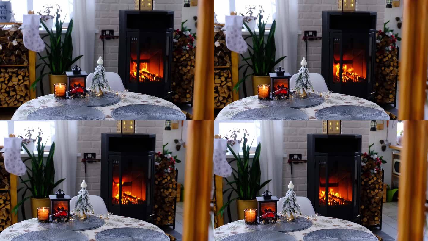 金属黑色的炉子，白色的燃烧壁炉，房子的节日内部装饰为圣诞节和新年，圣诞树。柴堆里的柴火，温馨温暖的家