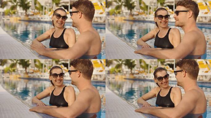 一对幸福的年轻情侣在度假胜地的游泳池里放松。暑假，浪漫之旅