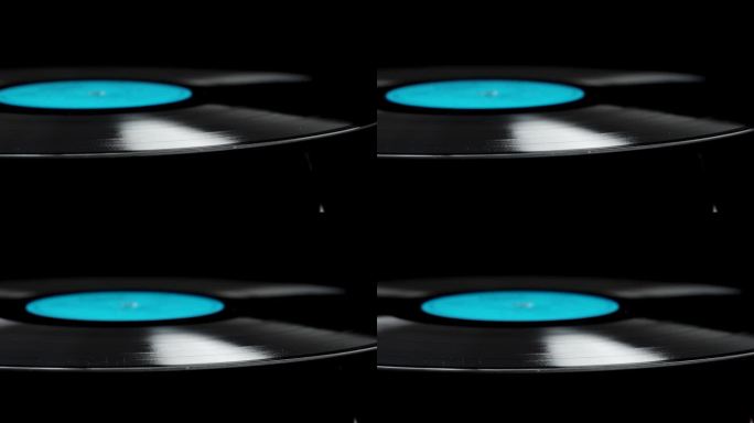 滑块沿着旋转黑胶唱片上的黑色背景，特写，孤立。蓝色的标签。