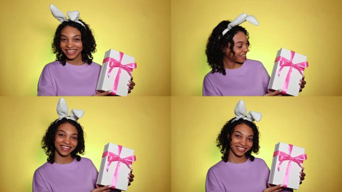 复活节快乐的女孩拿着兔子耳朵拿着礼盒微笑着。特别促销，销售，优惠，赠品的概念