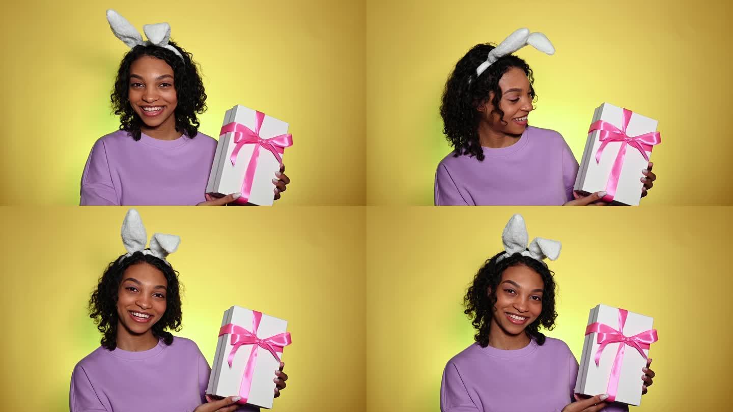 复活节快乐的女孩拿着兔子耳朵拿着礼盒微笑着。特别促销，销售，优惠，赠品的概念