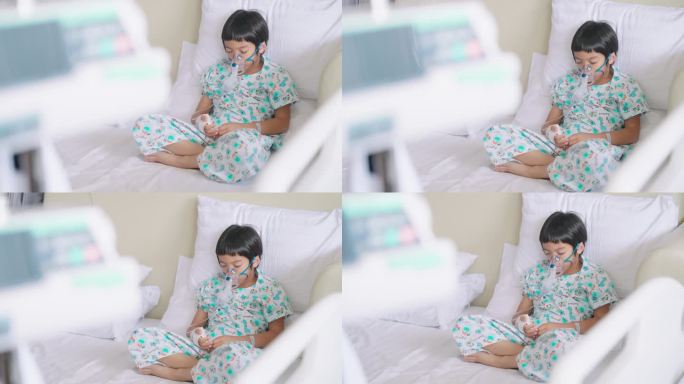 亚洲病人男孩戴着呼吸器面罩独自躺在病床上