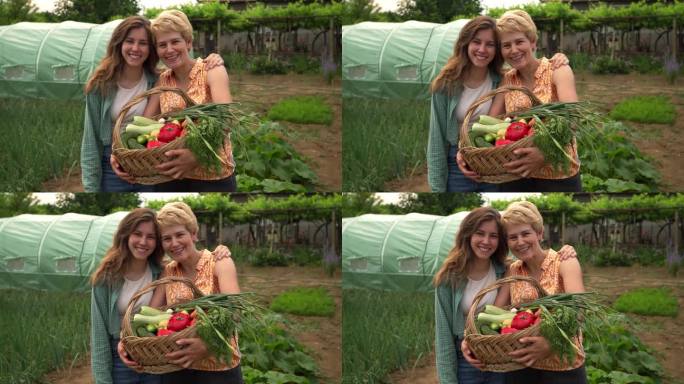 母女俩捧着一篮子自家种的蔬菜