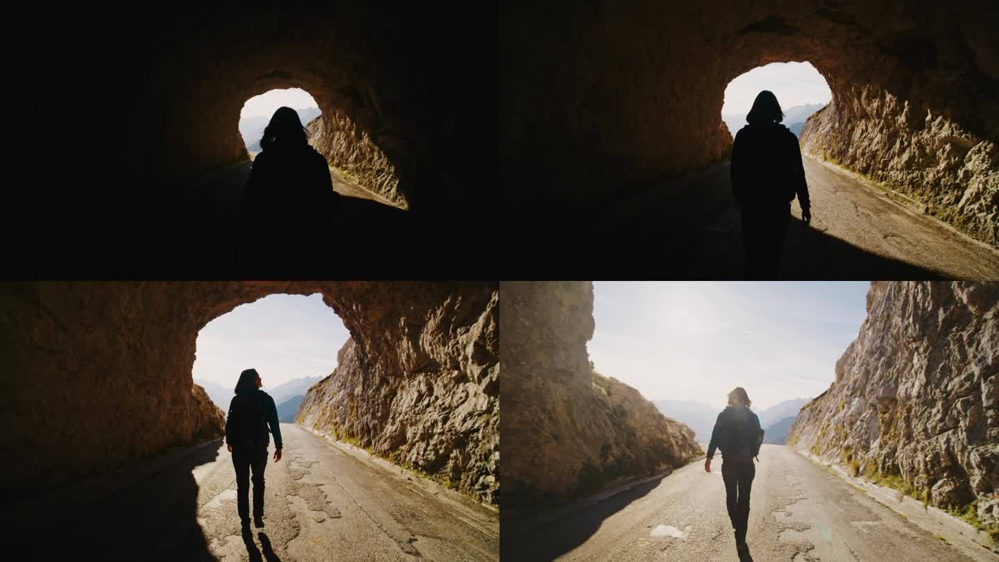 SLO MO出现在光:女人探索登山隧道的冒险