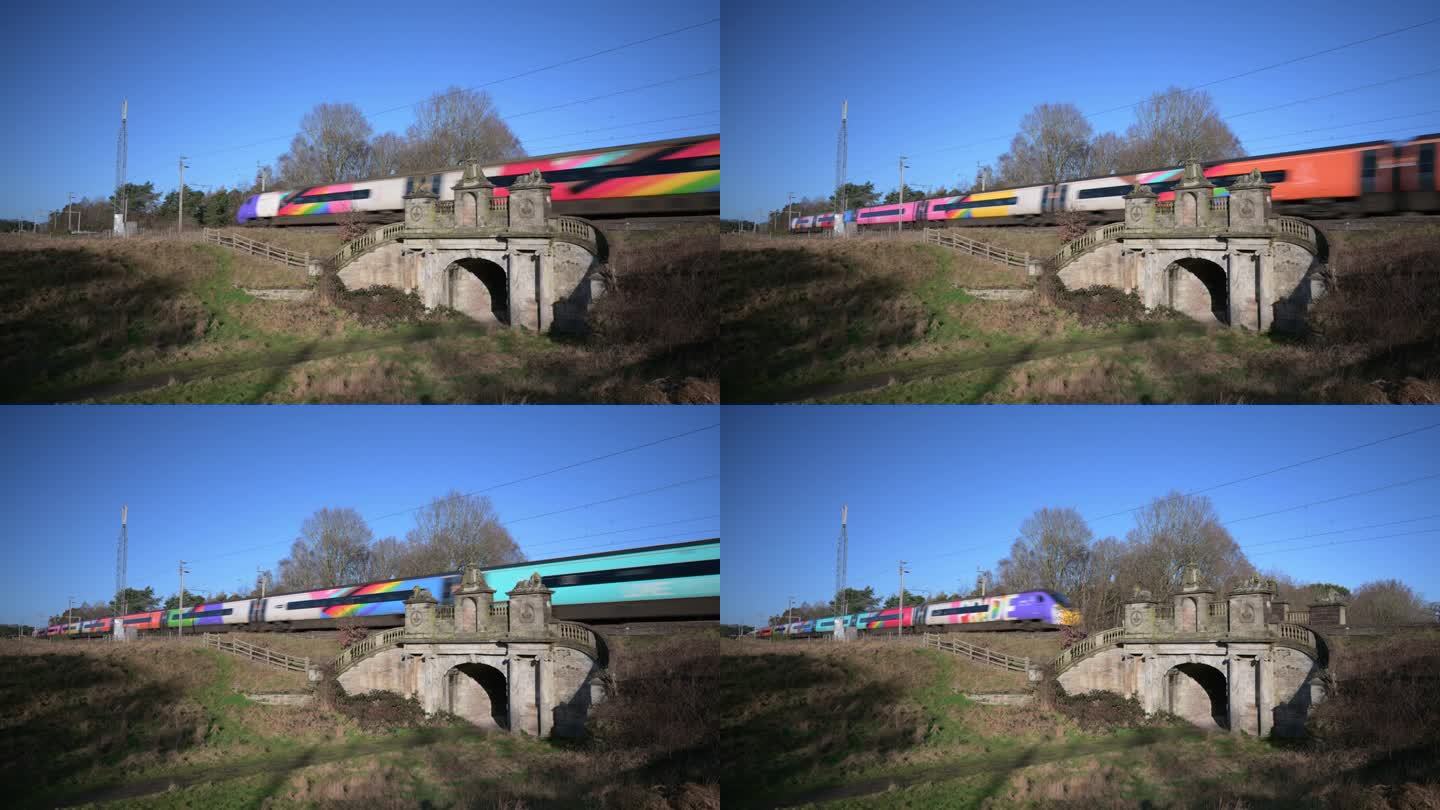 英国斯塔福德郡科尔维奇——2024年1月26日:一列客运列车驶过西海岸干线铁路上的一座铁路桥。