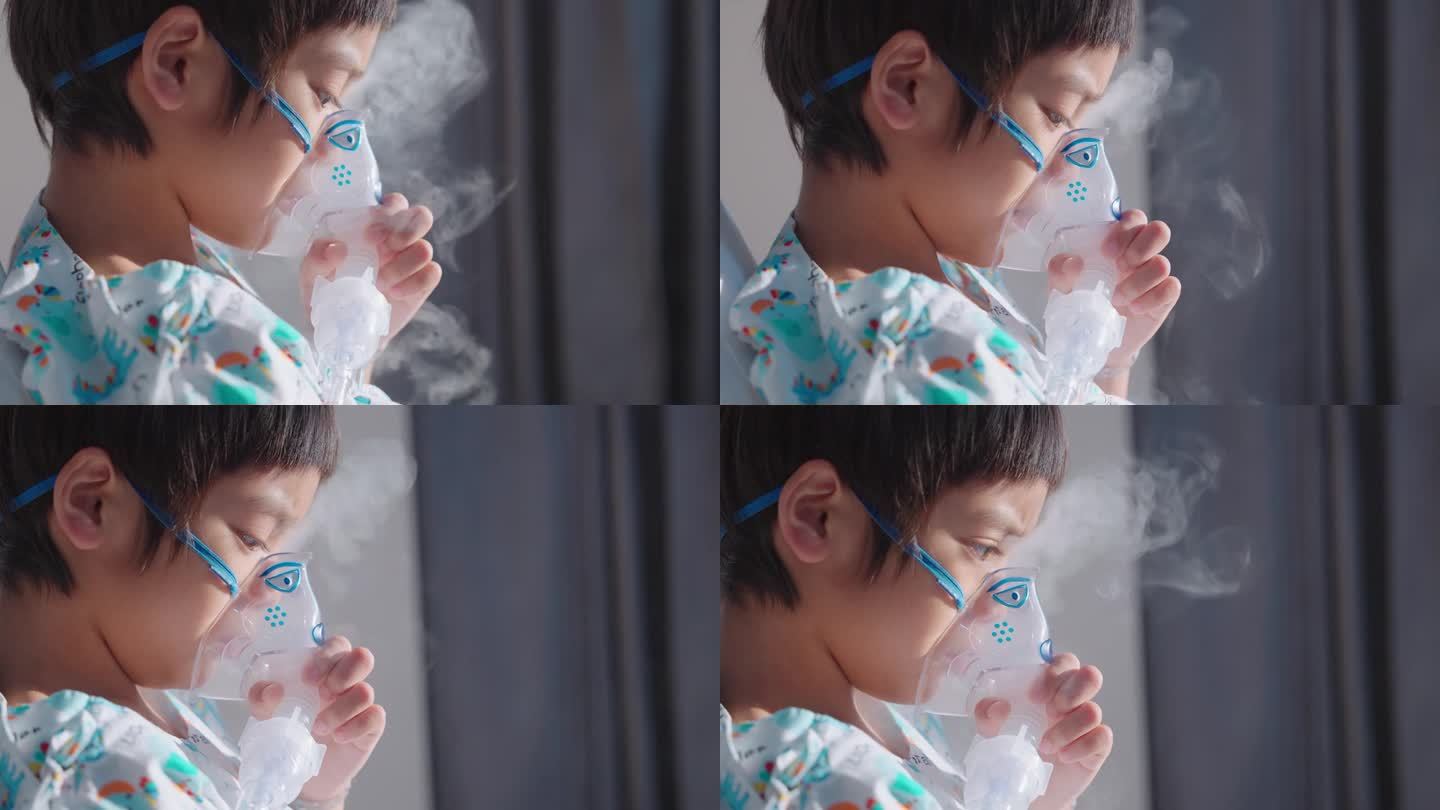 患病的亚洲男孩用吸入器呼吸，肺炎在医院康复