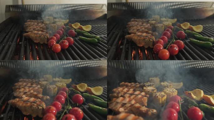 鱼片、西红柿和蔬菜在烧烤架上用明火烤着