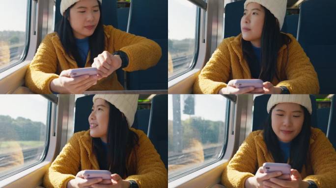 亚洲女性游客在乘坐火车、城际公共交通工具上下班时，一边用智能手机一边开心地看着窗外