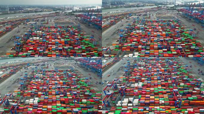 4K鸟瞰图实时拍摄的汉堡港货物转运枢纽和集装箱运输，集装箱堆叠，汉堡，德国