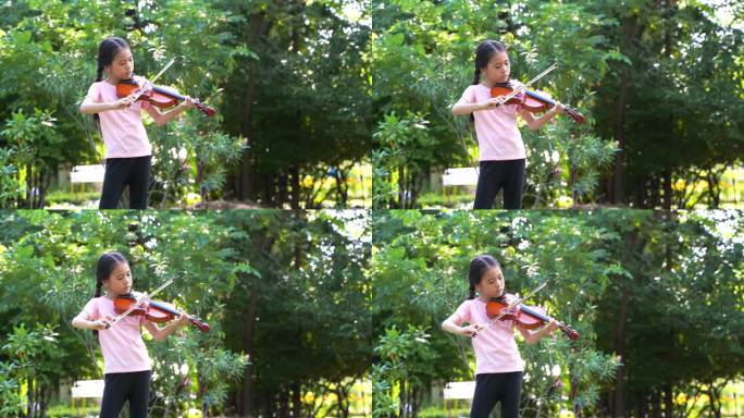 一个小女孩站在公园的长椅上。她低头看着小提琴，拉起小提琴时，她的脸很专注。