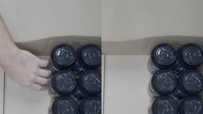 啤酒厂里，有纹身的工人正在把罐装啤酒装进盒子里。头顶球