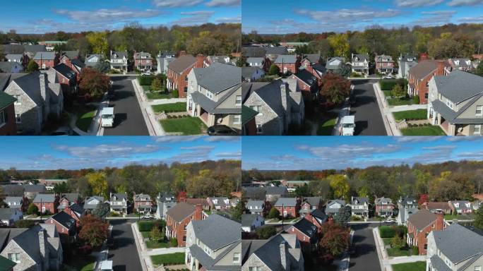 有砖房和晴朗蓝天的郊区街道。美国邮政邮车的空中上升照片。