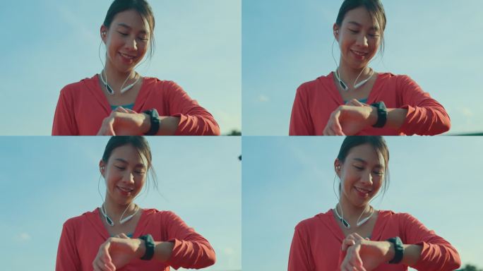 年轻的亚洲女运动员跑步者在户外跑步前检查智能手表的进度和看智能手表心率监测器。健康的锻炼。