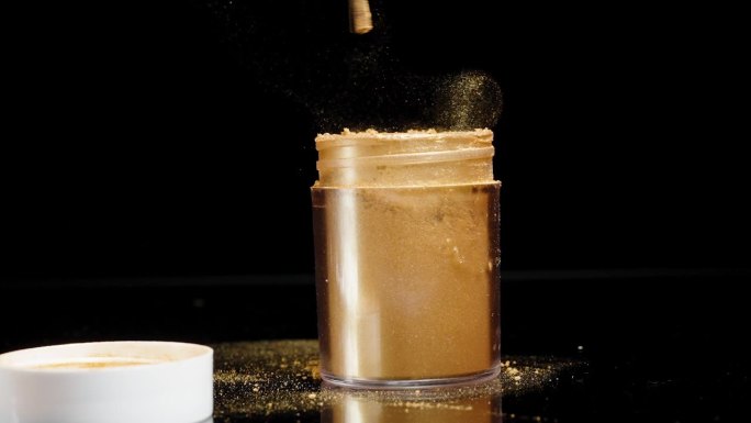 把刷子从罐子里的金粉上一抖，金粉的颗粒就会在黑色的背景上慢慢地散开。