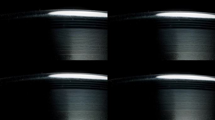 黑胶唱片上螺旋声轨槽的宏观视图。放大。