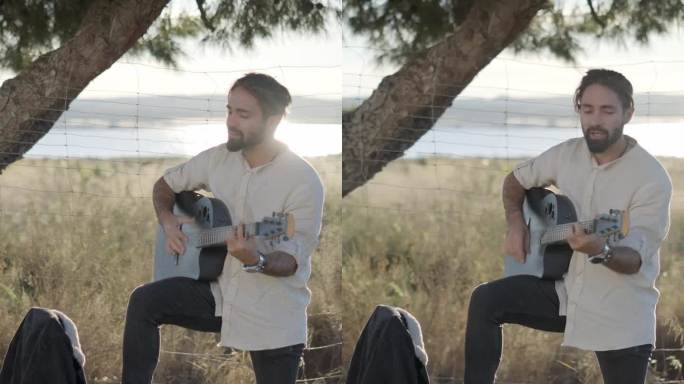 西班牙男子在路边弹吉他，站在路边唱歌，看着相机在日落西班牙乡村慢镜头