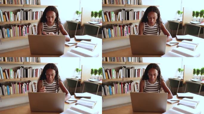 漂亮的非洲女孩在网上学习，坐在书桌前使用笔记本电脑