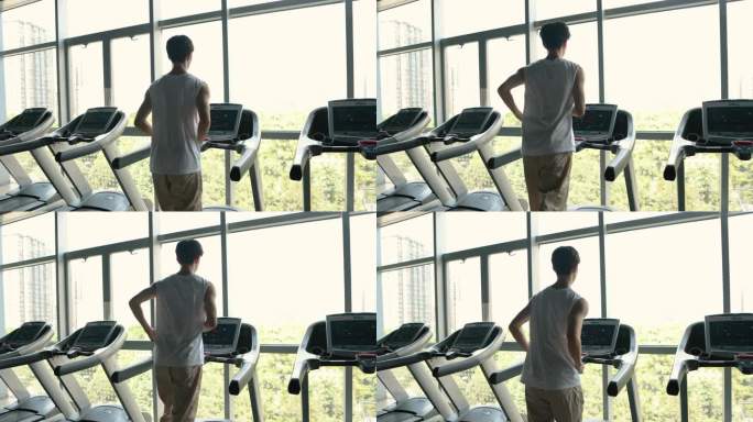 一个男人在健身房启动他的跑步机，准备跑步——健康的生活方式，健康和健身训练，快乐和健康