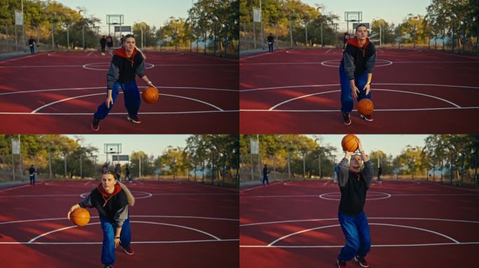 夏天的街头，一个穿着运动服和蓝色裤子的金发女孩，在地板上弹起一个橙色的篮球，用它做动作，然后把它扔进