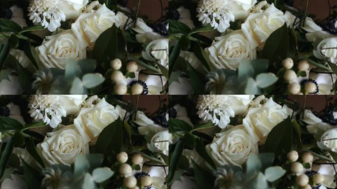 白玫瑰婚礼花束在电影旋转。相机优雅地围绕中心旋转。完美的婚礼录像，浪漫的蒙太奇，或庆祝时刻。