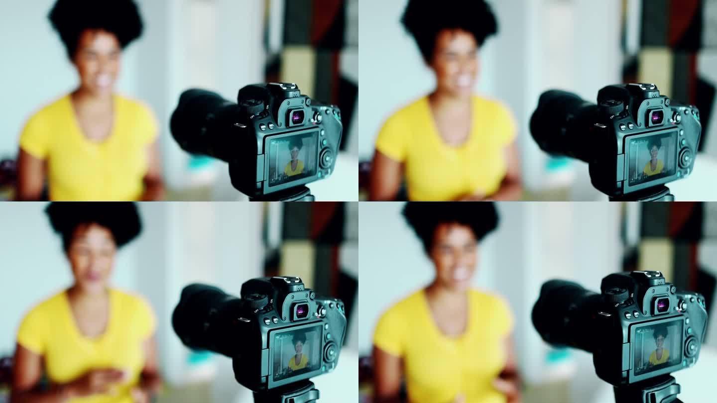 摄像机特写拍摄视频博主，背景模糊，女性为网络频道制作推荐视频，从事新媒体传播