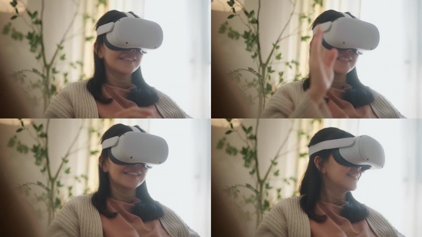 年轻的亚洲孕妇戴上虚拟现实眼镜，坐在家里的客厅里，进入虚拟模拟世界的在线聊天会议。