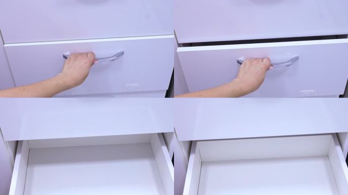 女人用手拉着把手打开一个白色橱柜的空抽屉