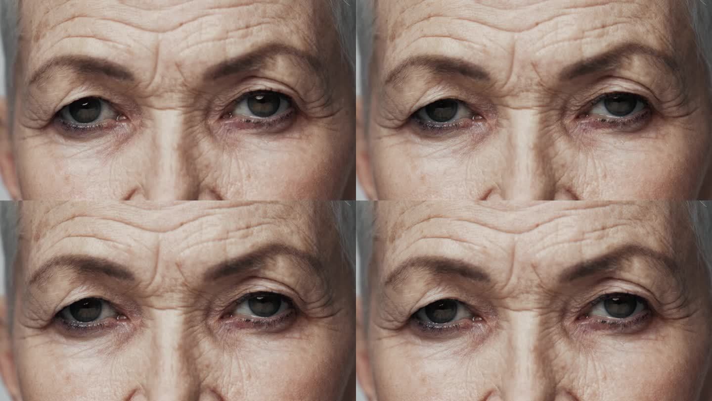 老妇人的脸，眼睛睁得大大的，看着相机的特写。一个老年人的严重视力与老年特征。关于退休的现代观的思考