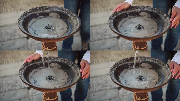 老旧的老式饮水机的特写镜头与流动的干净的淡水