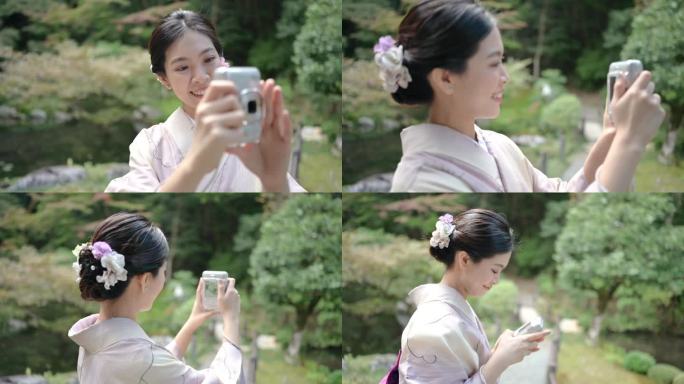 穿着和服的日本女青年和她的朋友用即时照相机拍照
