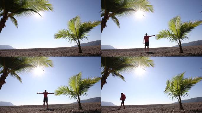 哥斯达黎加海滩上的两棵棕榈树。一个男人走在他们中间，伸着懒腰。