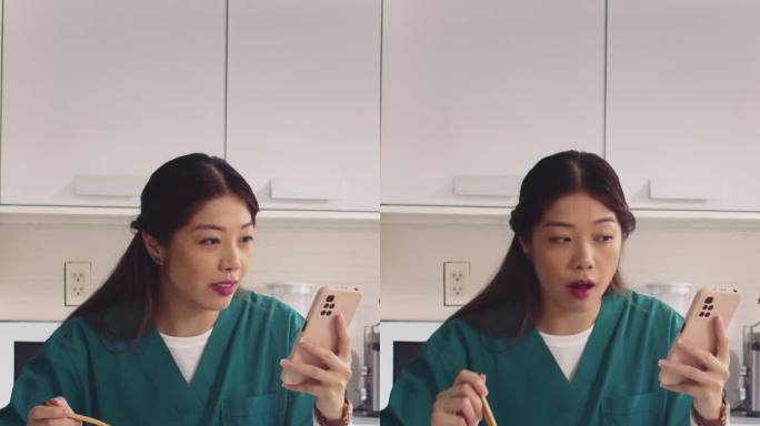 亚洲护士在厨房吃酸奶和使用电话
