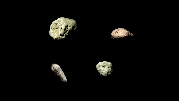 四颗小行星绕着它们的轴旋转，在黑色的背景上分开。一组4个旋转的小行星。4k慢动作视频。