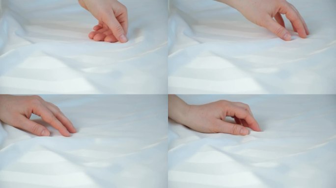 天然缎面织物的精致。女人用手抚摸着床单的表面