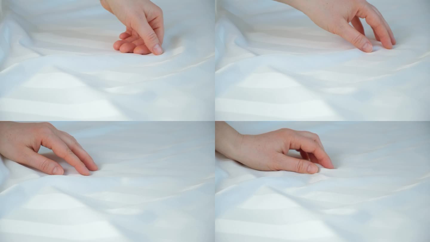 天然缎面织物的精致。女人用手抚摸着床单的表面