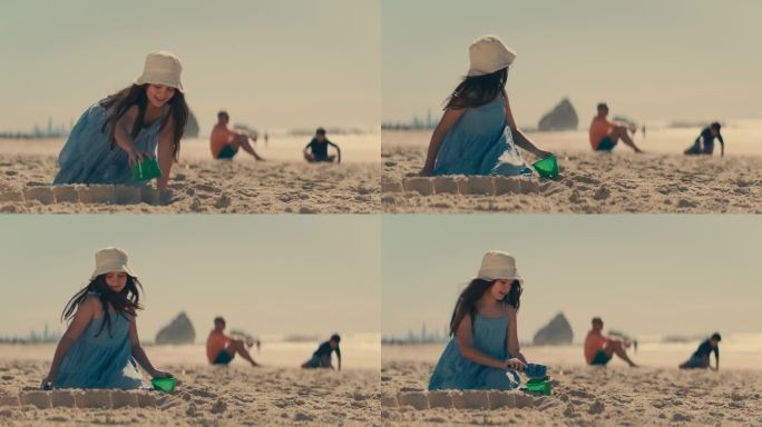 小女孩在沙滩上堆沙堡