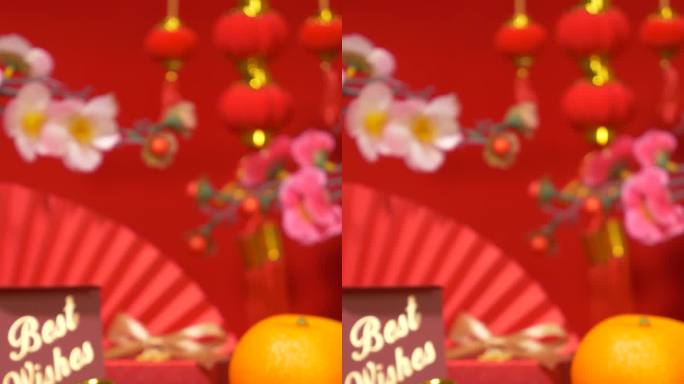 中国农历新年背景的环形垂直。中国古代金条，带文字祝福的红色礼盒，橘子，纸扇，梅花枝，蜡烛摇曳，红纸灯