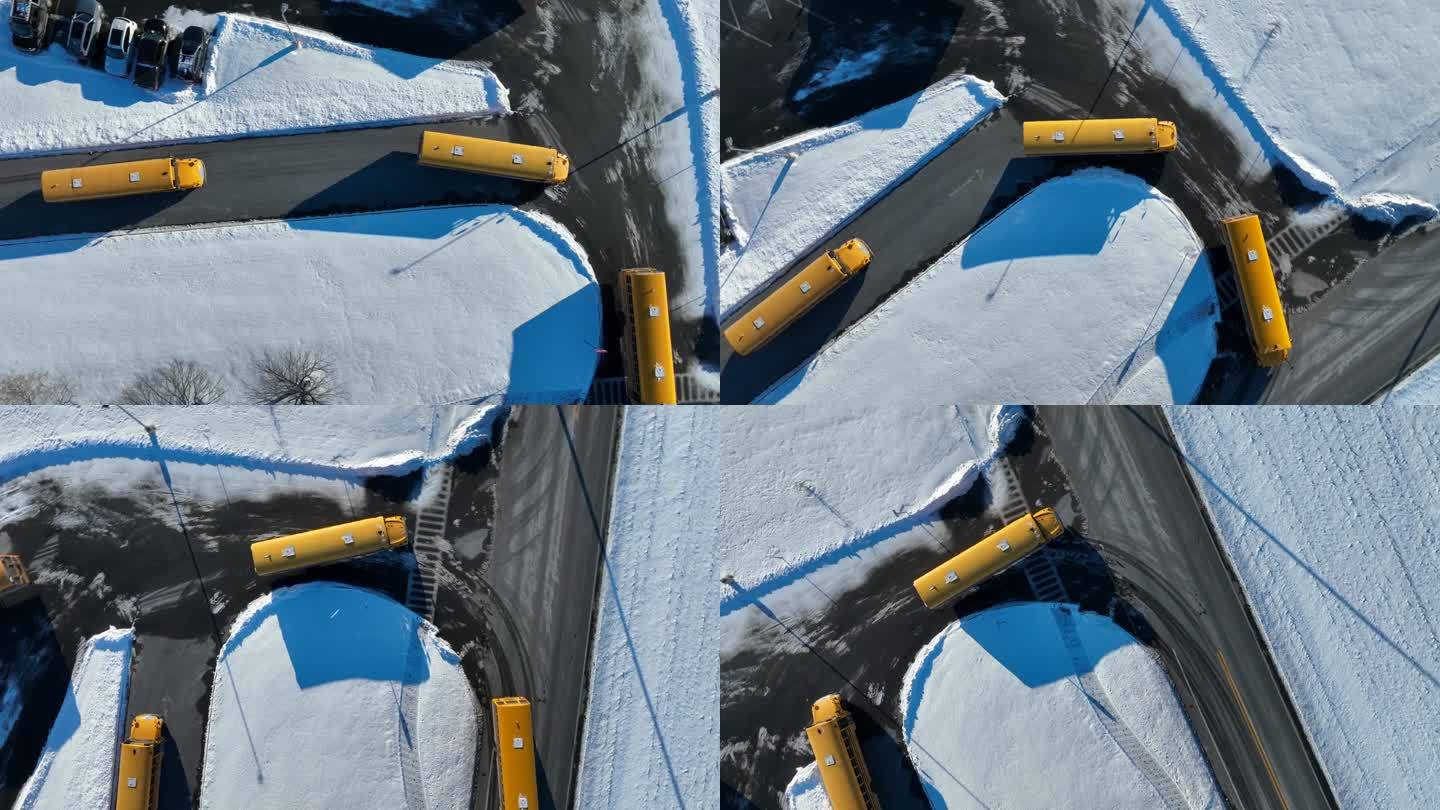 下雪天运送公立学校学生的黄色校车。从上到下的空中跟踪拍摄在下雪的校园。