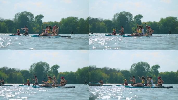 夏季的划板之旅，一群运动员在河上的充气板上漂浮