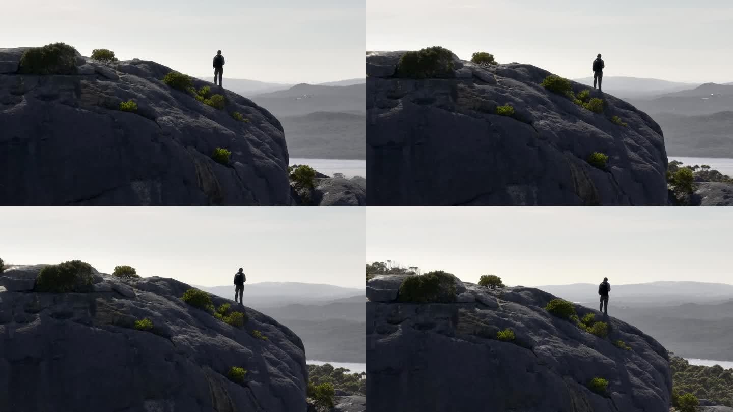 一个人站在悬崖边上的缓慢移动的视差。